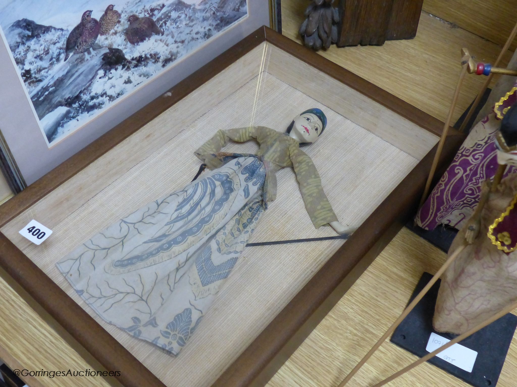 Three Indonesian stick puppets and another framed puppet, tallest 59cm